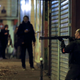 A French police officer takes cover while on the lookout for the shooters who attacked the restaurant Le Petit Cambodge.